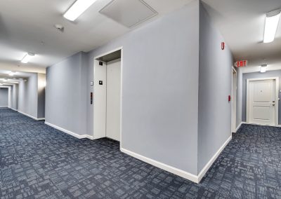 Carpeted Hallway by elevator